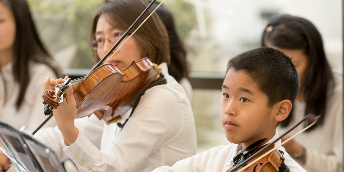 Pacific Symphony students playing orchestra in an ensemble