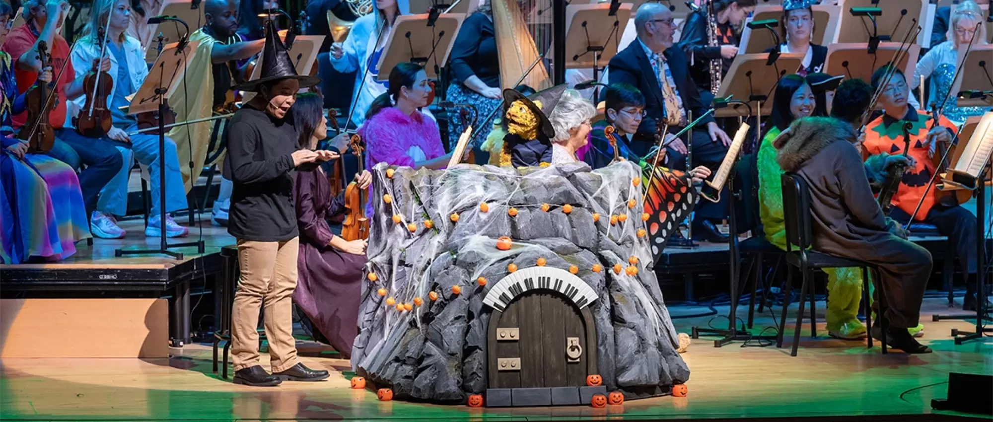 Leopold the Leopard puppet on stage with musicians of Pacific Symphony