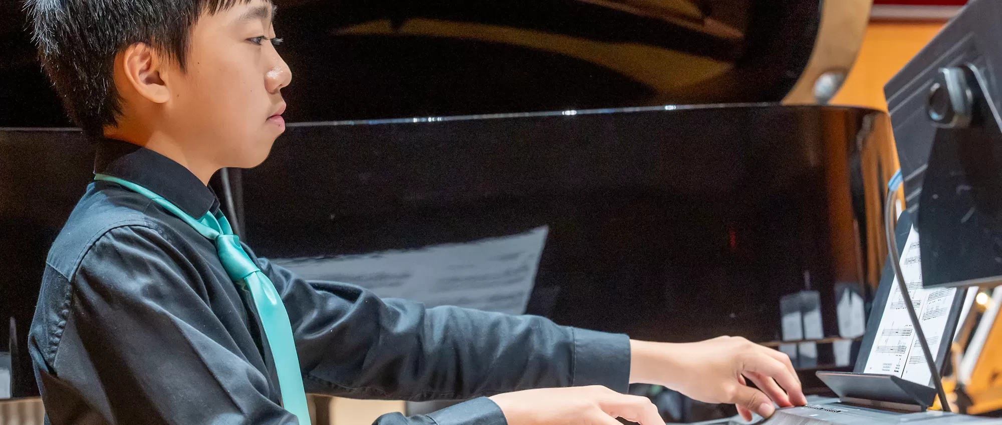 Member of Pacific Symphony Youth Concert Band playing keyboard
