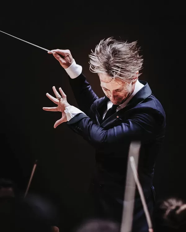 Alexander SHelley conducting with his hair flying