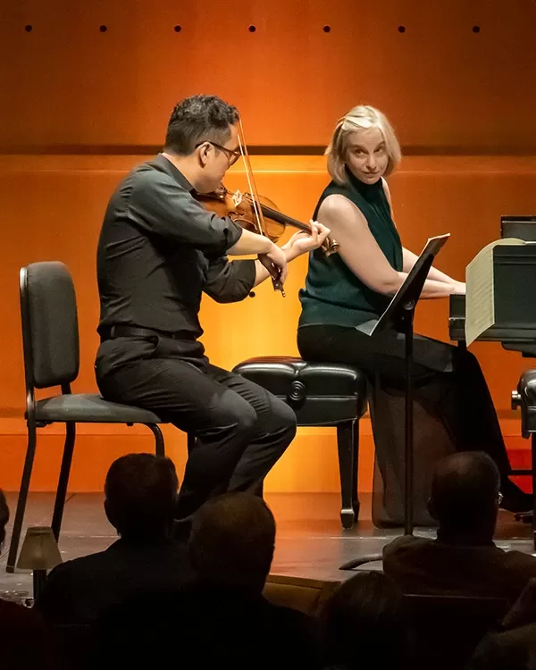 violinist and pianist performing on stage
