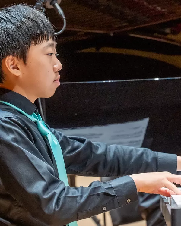 Member of Pacific Symphony Youth Concert Band playing keyboard