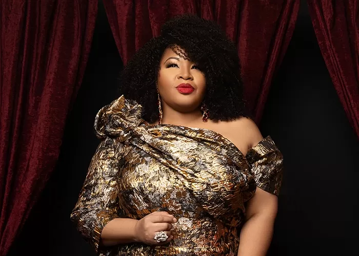 Soprano Karen Slack in a shiny gold dress