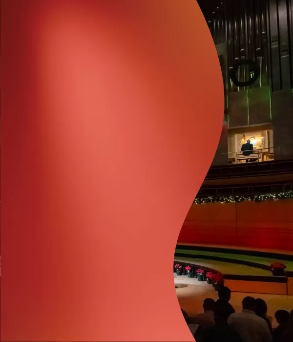 Segerstrom Concert Hall stage with Christmas decorations and musicians at the organ and a small ensemble on the stage