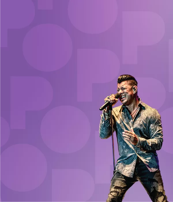 Rock musician singing into a microphone