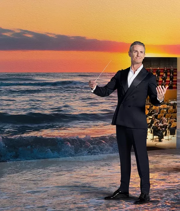 Sunset over the ocean with a conductor and musicians