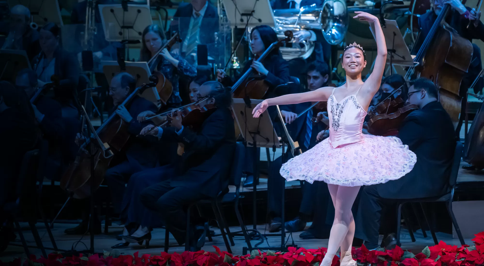 a ballerina dancing in front of an orchestra