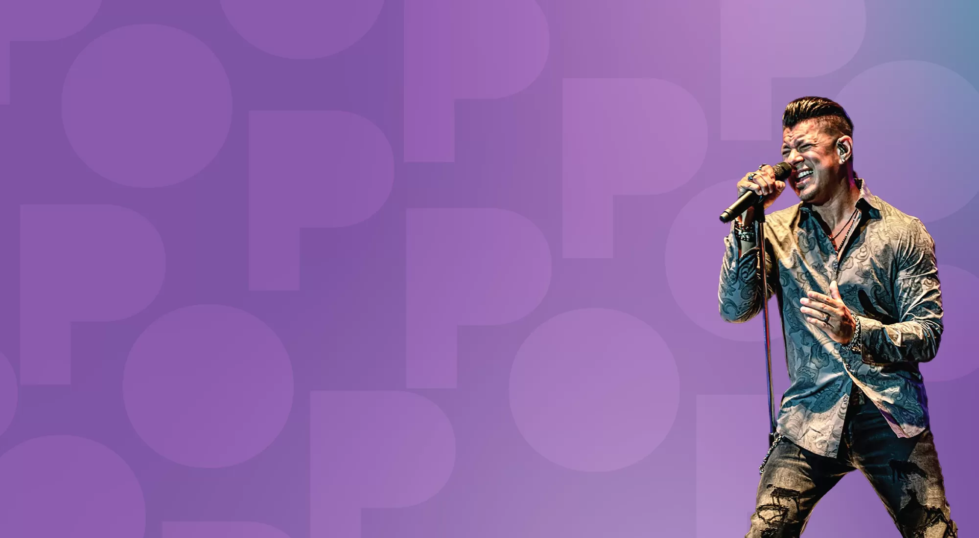 Rock musician singing into a microphone