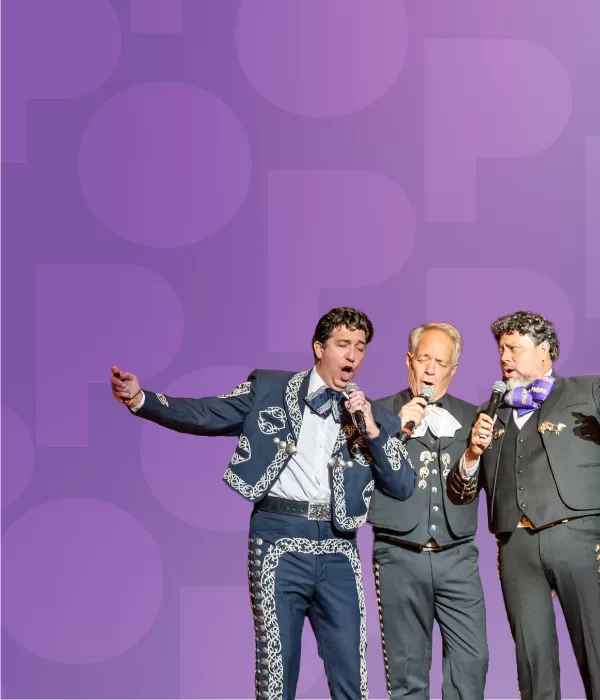 Three singers in Mexican suits